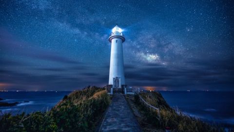 Lighthouse under the Milky Way on a remote Japanese cape at night